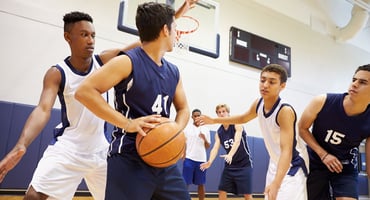 High school students play basketball for their school