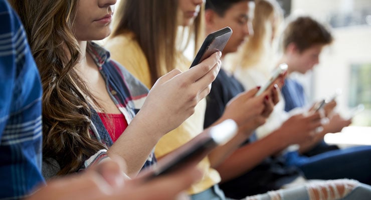 Students looking at their smartphones. 