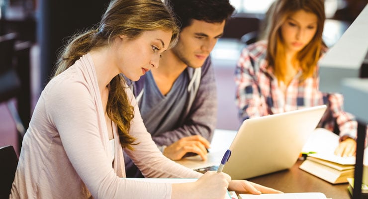 Three college students study together for a test.