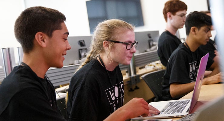 USF Summer Program students working together on computers.