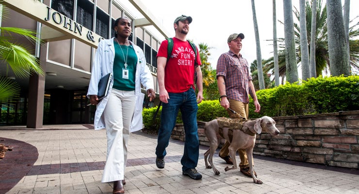 USF veterans walk through campus with an advisor.