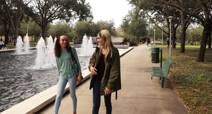 Two USF students take a walk at the MLK Plaza.