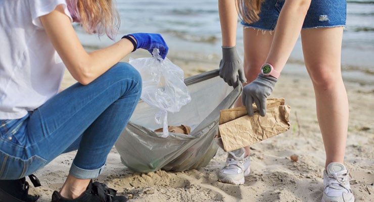 Two female students spend their gap year after high school removing litter from beaches