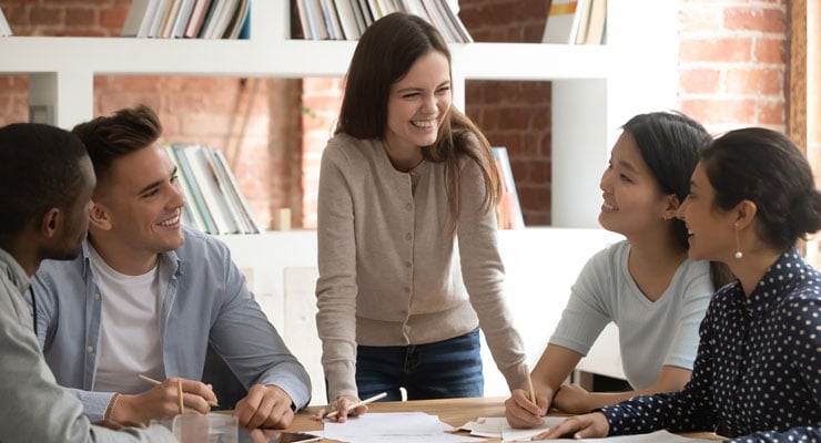 Female student leader guiding others students through a meeting.