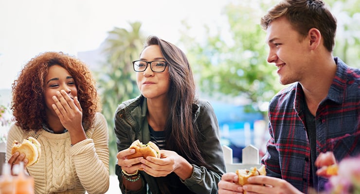 Three students eating together.