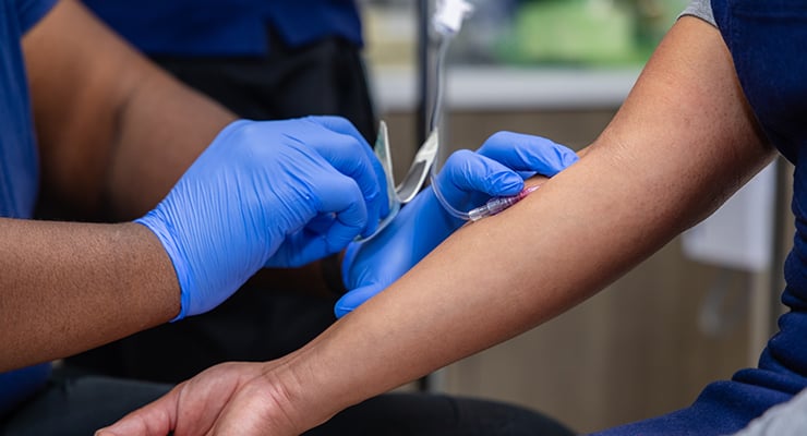 A nurse inserting a needle.