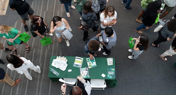 Students walking around a college fair.