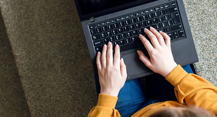 Top-down view of a student using a laptop.