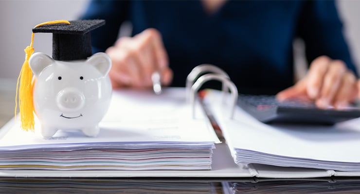 A piggy bank wearing a graduation cap representing financial aid.