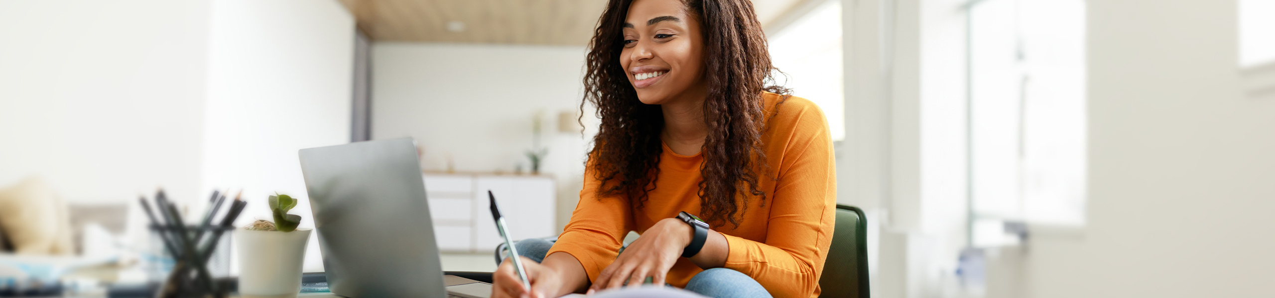 A student smiling while taking notes.