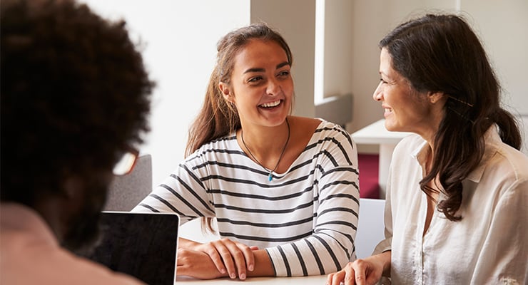 A student and her mother both smiling.