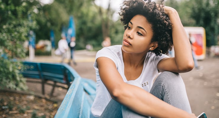 Woman sitting on a bench.