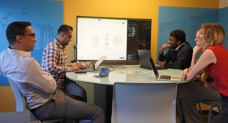 A group of five professors having a conversation.