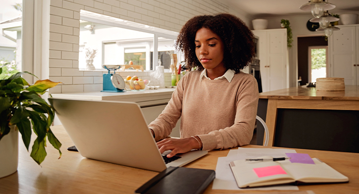 A girl typing on her laptop.