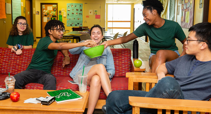 College students enjoy snacks together in their residence hall.