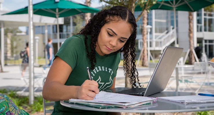 Image of USF student writing a list of priorities