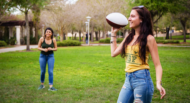 USF students enjoying a day outside playing football.