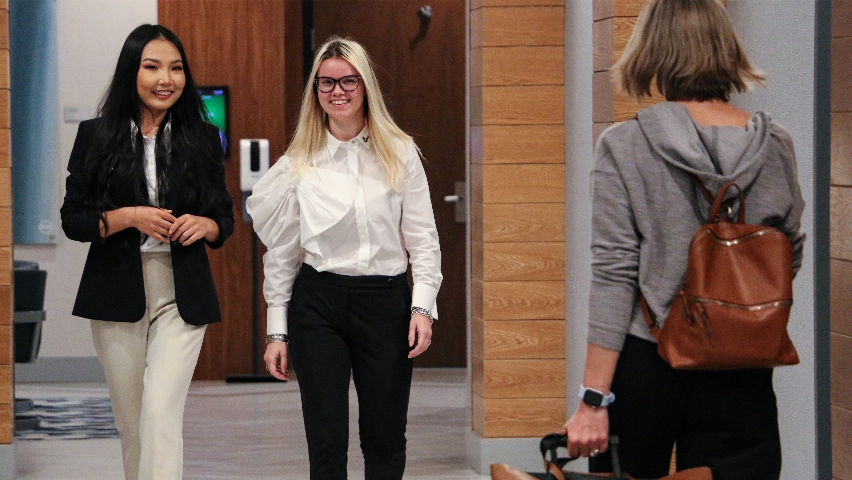 USF business students walking and smiling.