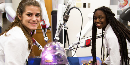 Two female USF students conducting an experiment in one of their pre-college courses.