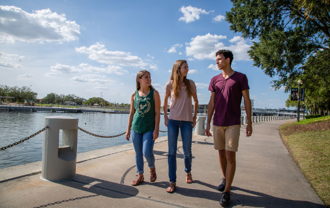 USF students walking together exploring tampa activities by the water.