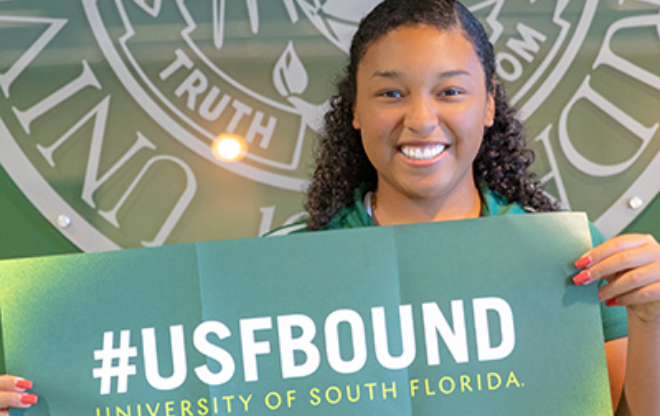 Recently admitted female USF student just holding up bull sign.