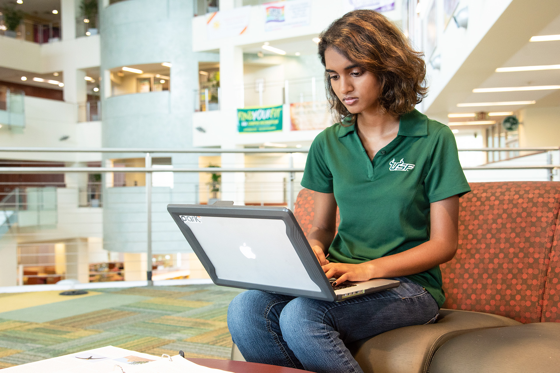 Female USF student looking up USF statistics and tuition information on her laptop.
