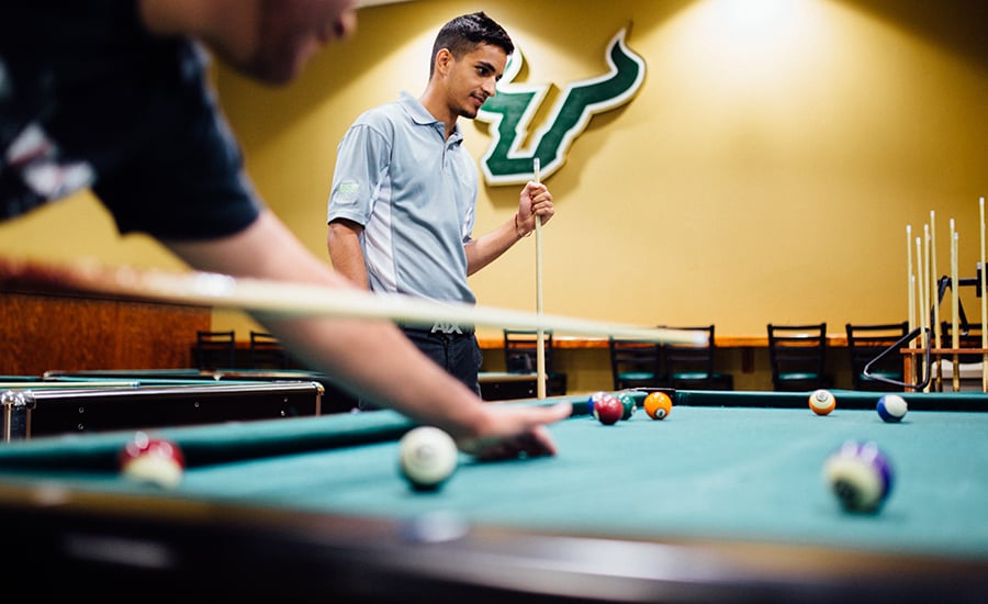 USF students playing pool together on campus.