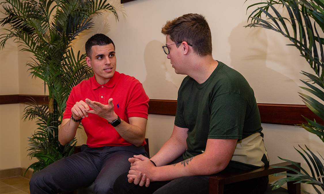 A college counselor helping a male student learn about career options available to him.